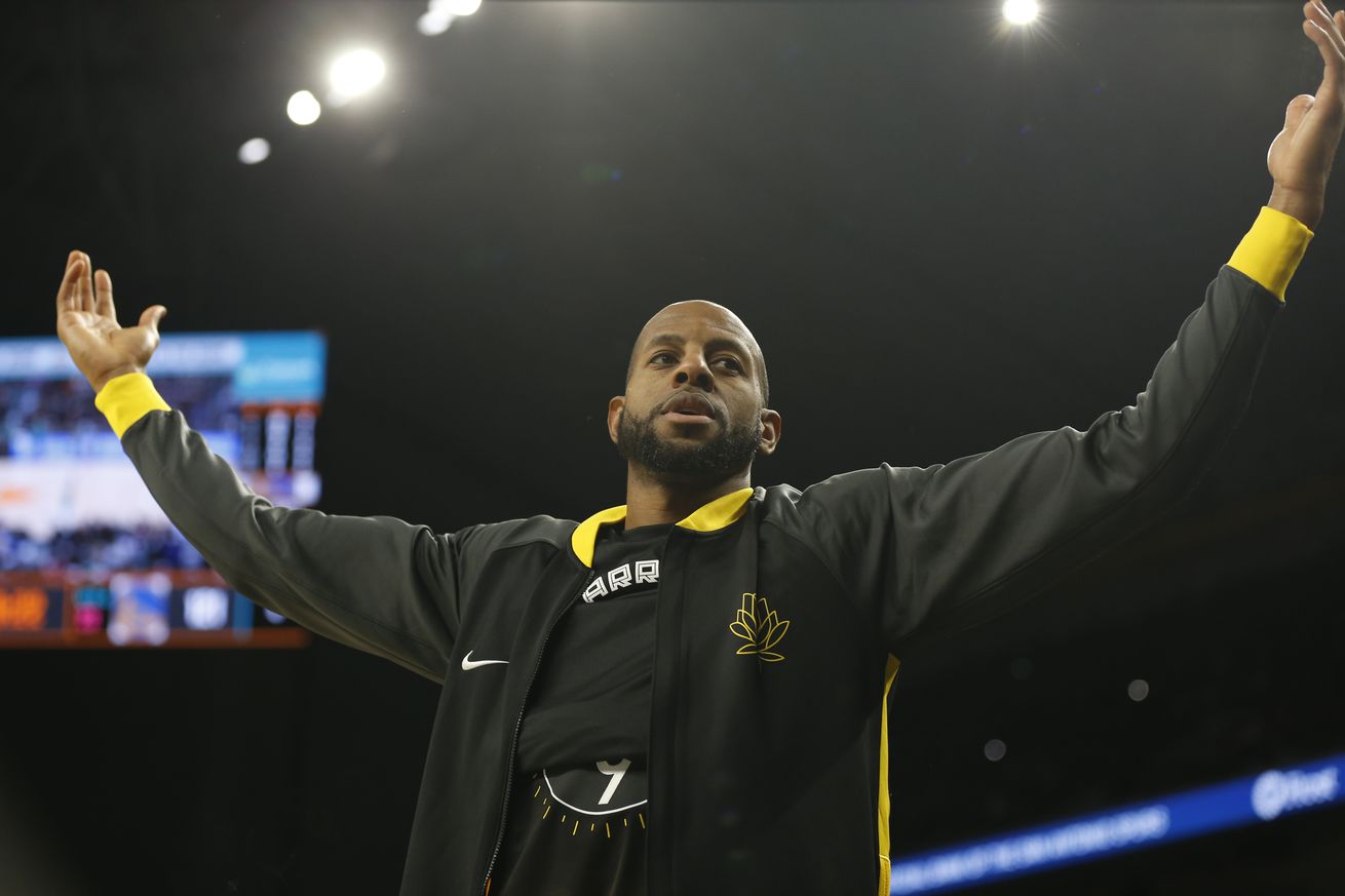 Andre Iguodala in his warm up jersey, with his arms out 