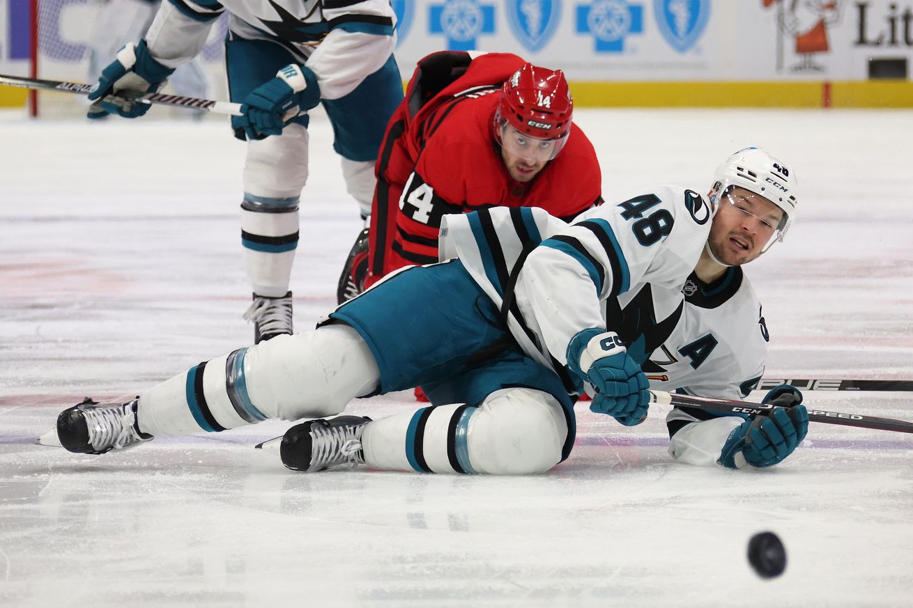 Tomas Hertl #48 of the San Jose Sharks loses a edge in front of Robby Fabbri #14 of the Detroit Red Wings during the third period at Little Caesars Arena on January 24, 2023 in Detroit, Michigan. Detroit won the game 3-2 in overtime.