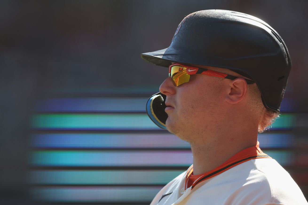 Profile of Joc Pederson, wearing a batting helmet and sunglasses 
