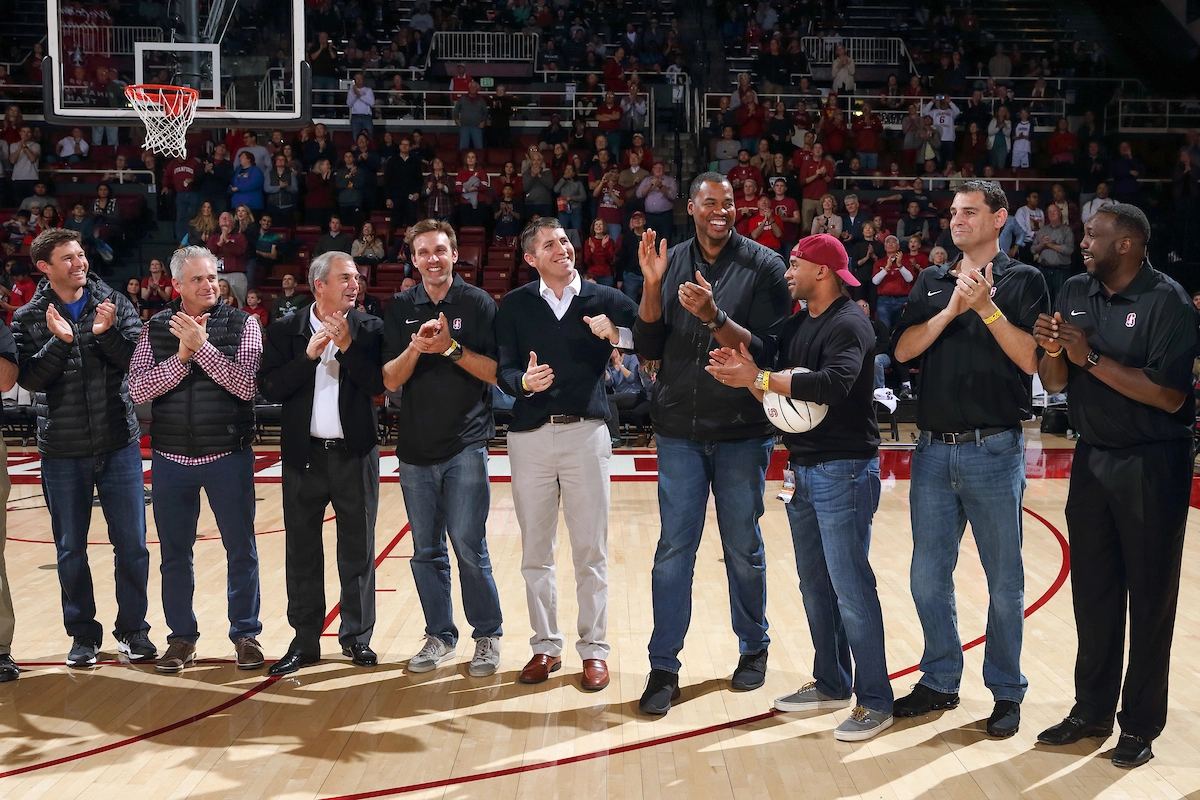 Stanford basketball and the Final Four run 1 A group of men stand on a basketball court clapping.