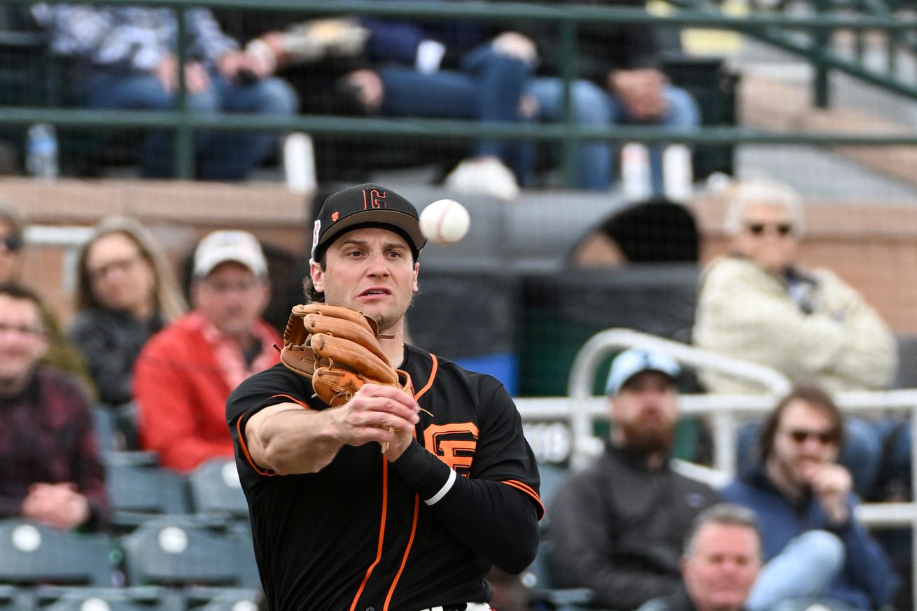 Casey Schmitt making a throw across his body