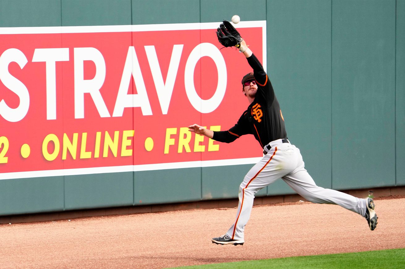 Wade Meckler reaching up to make a catch in the outfield