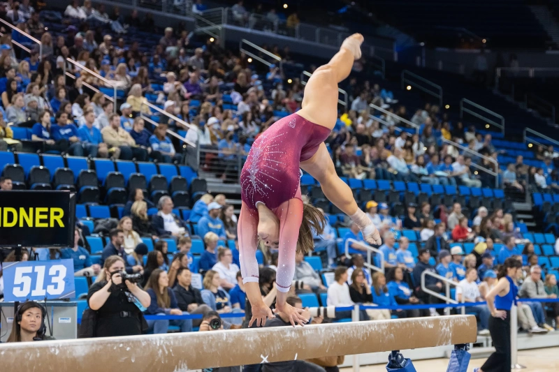 This Week in Sports: A four-peat for men’s gymnastics 1 A women doing a flip on a beam