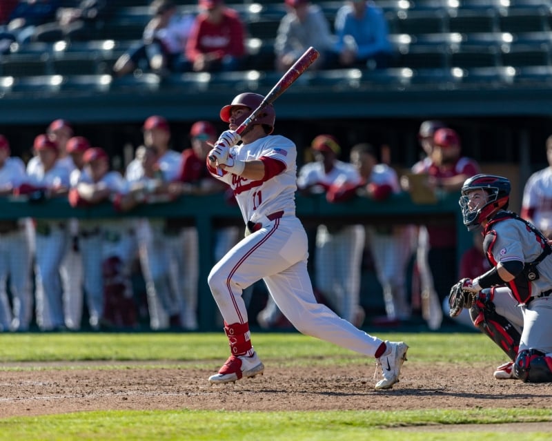 This Week in Sports: Three teams win conference titles, seven players headed to NFL 2 A batter looks at a baseball after hitting it, post swing.