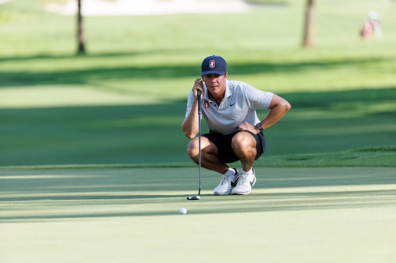 This Week in Sports: Three teams win conference titles, seven players headed to NFL 1 golf player bends down and looks closely at a golf ball after putting it