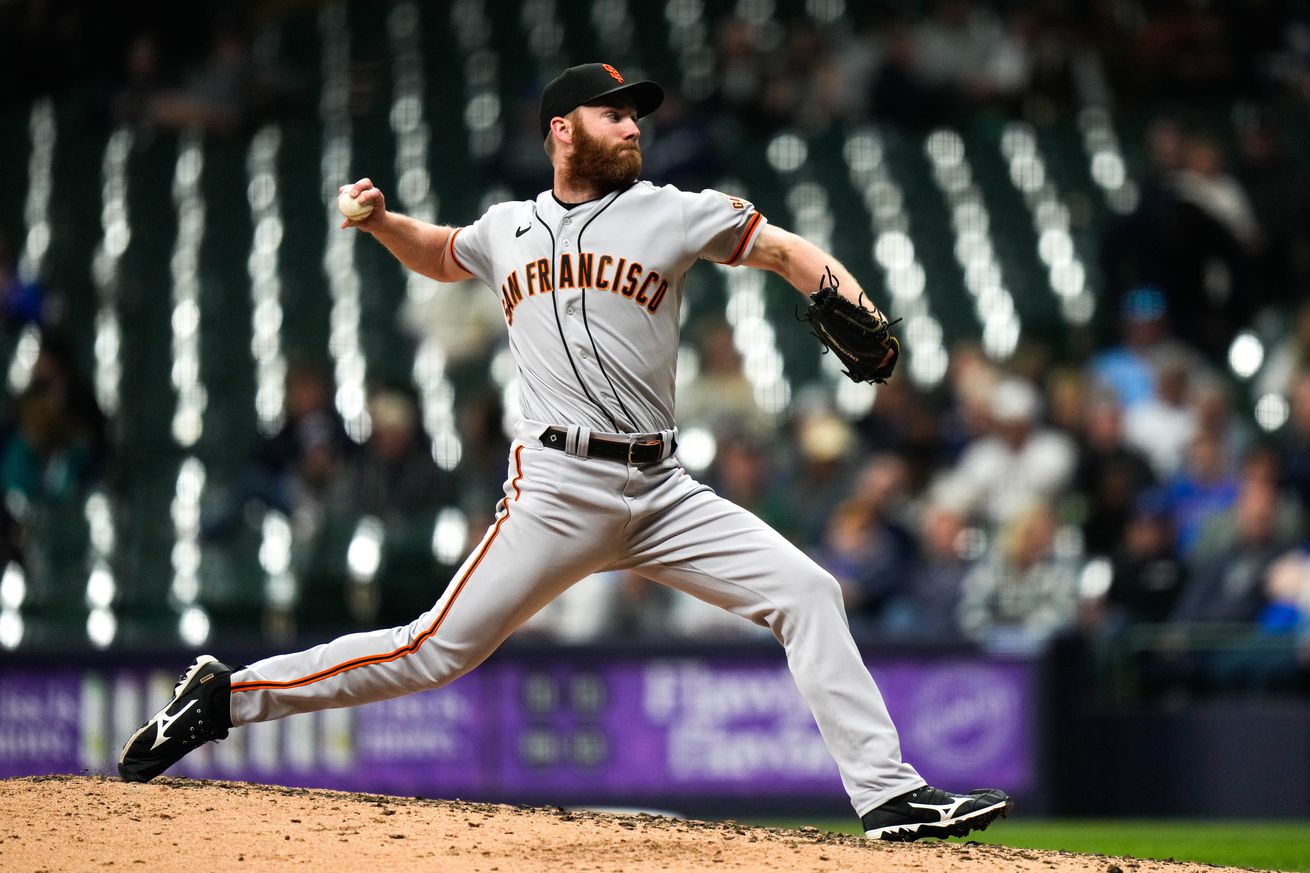 John Brebbia reaching back to throw a pitch