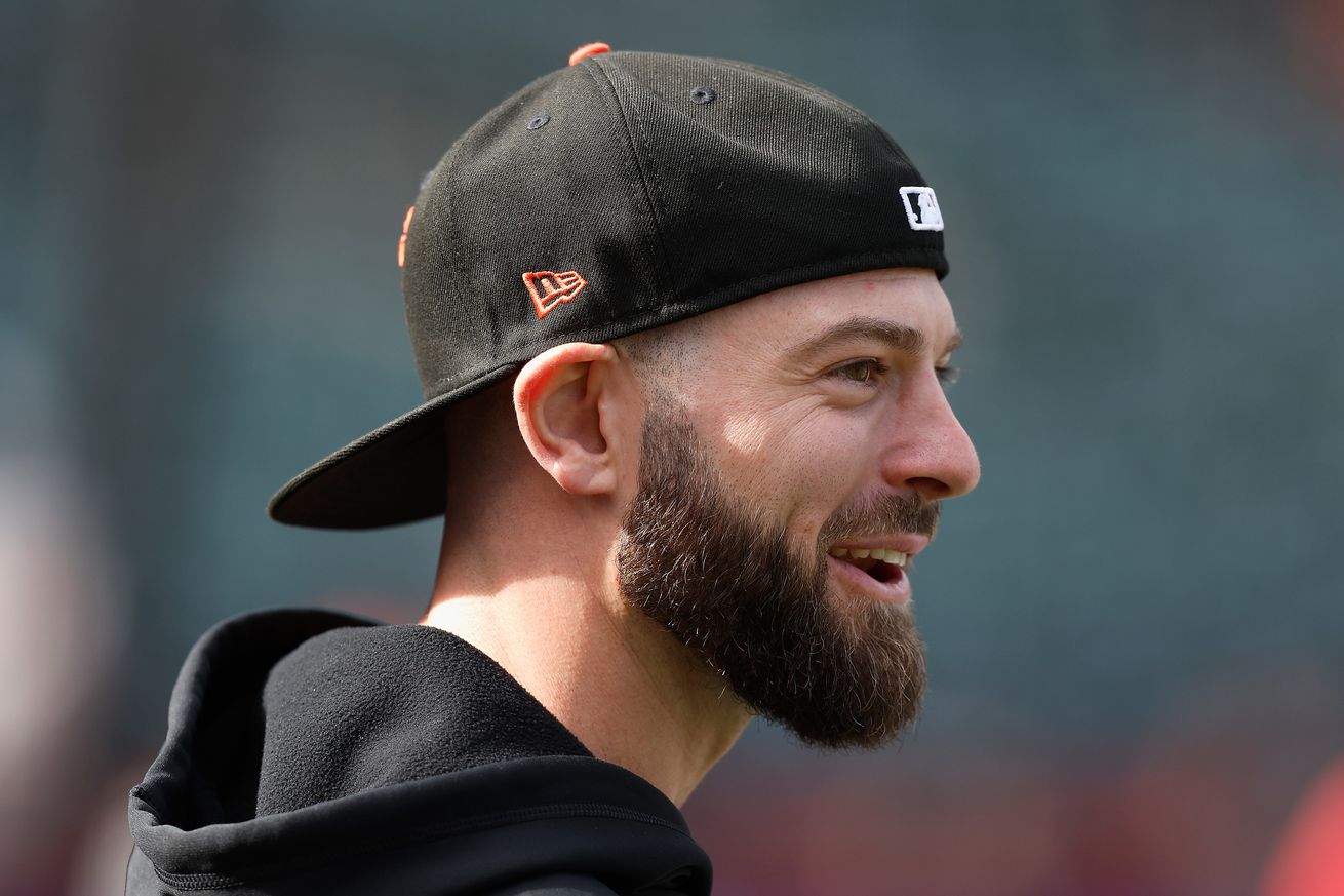 Mitch Haniger smiling while wearing a backwards cap