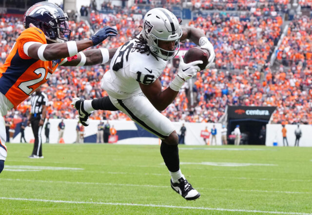 Sep 10, 2023; Denver, Colorado, USA; Las Vegas Raiders wide receiver Jakobi Meyers (16) catches a touchdown pass with Denver Broncos cornerback Damarri Mathis (27) defending in the first quarter at Empower Field at Mile High. Mandatory Credit: Ron Chenoy-USA TODAY Sports Jakobi Meyers, Raiders