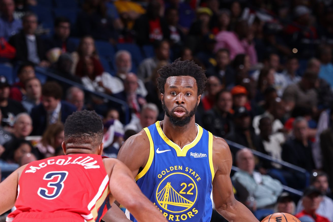 Andrew Wiggins dribbling while defended by CJ McCollum.