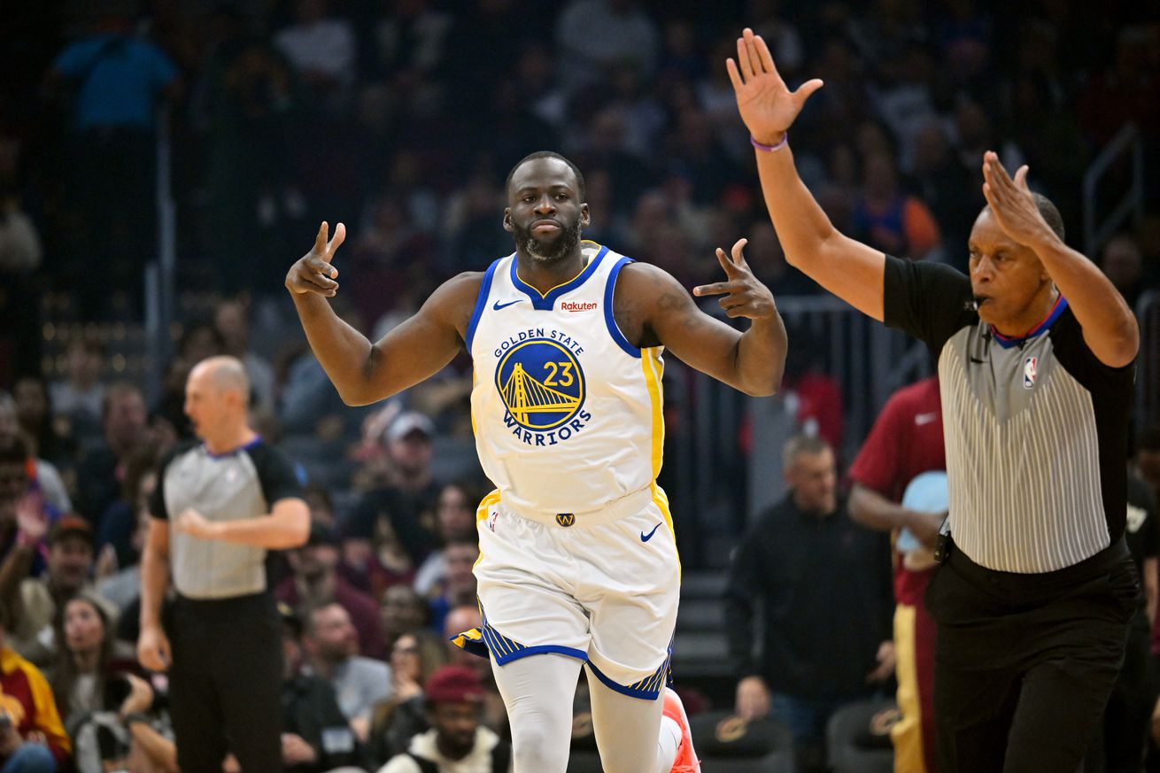 Draymond Green celebrates while running up the court.