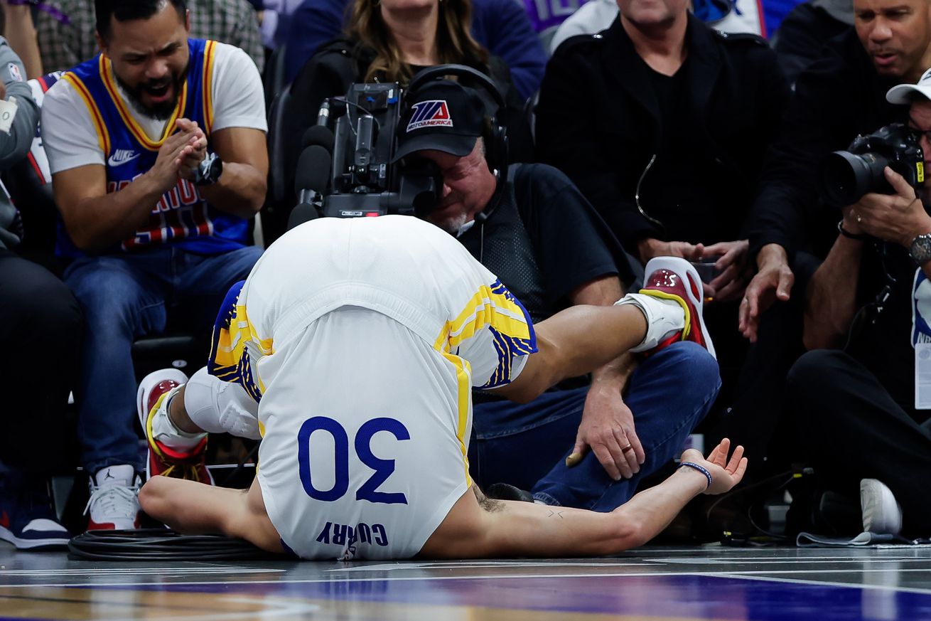 Steph Curry upside down on the court.