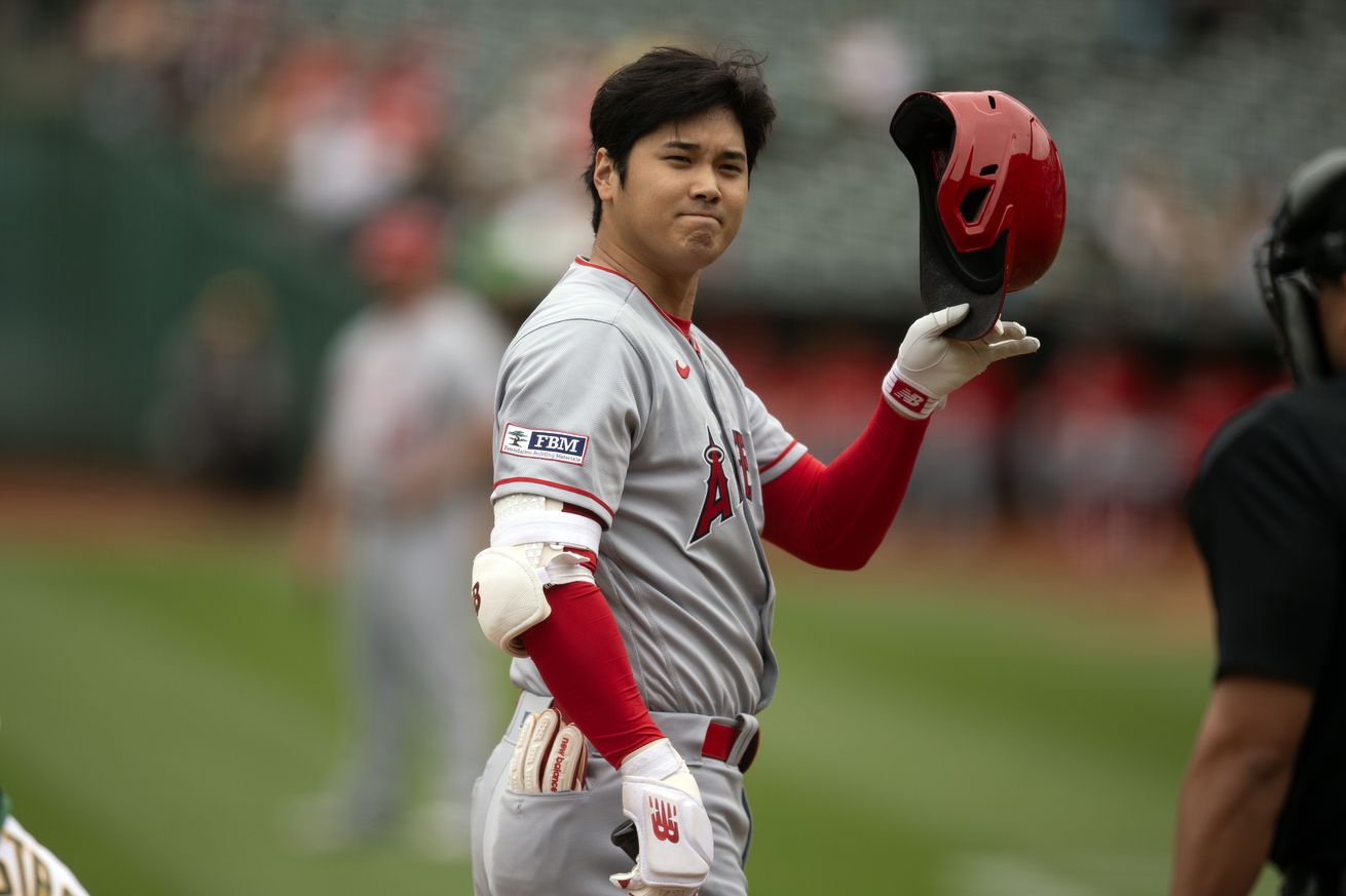 Shohei Ohtani tipping his batter’s helmet.