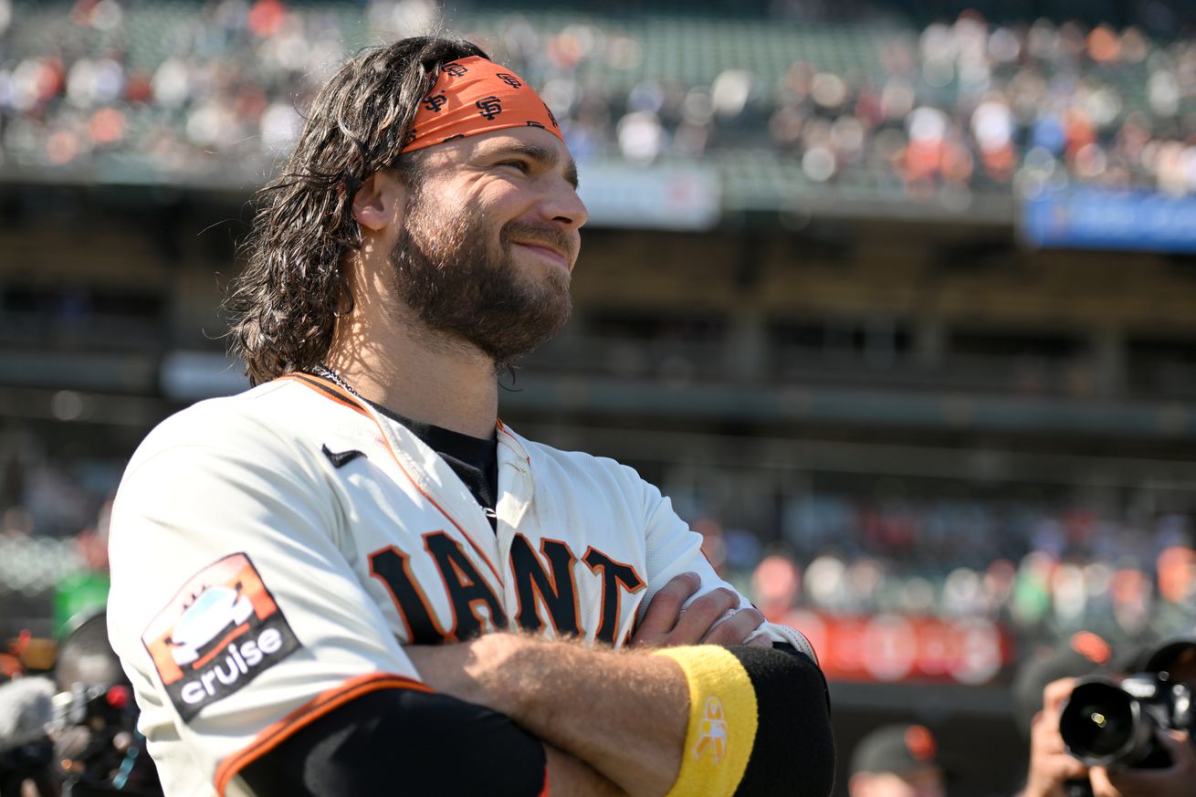 Brandon Crawford smiling and looking at the crowd.