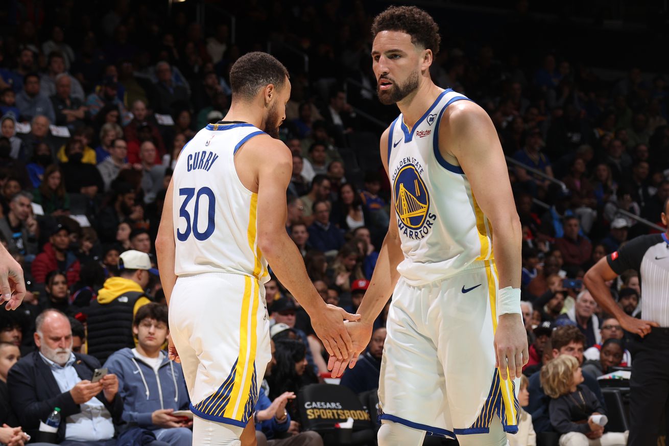 Klay Thompson low-fiving Steph Curry.