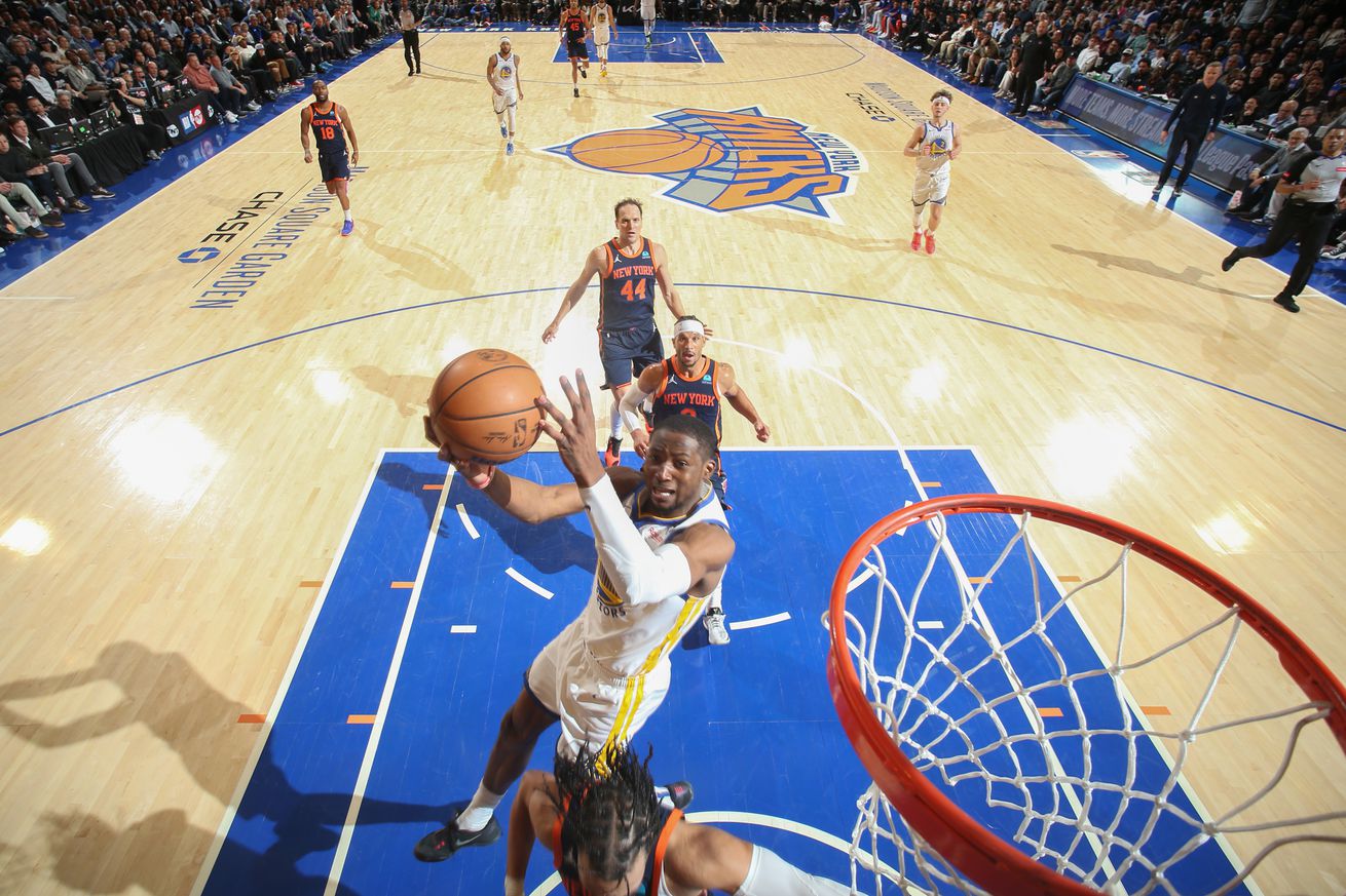 Jonathan Kuminga flying in air for a layup. 