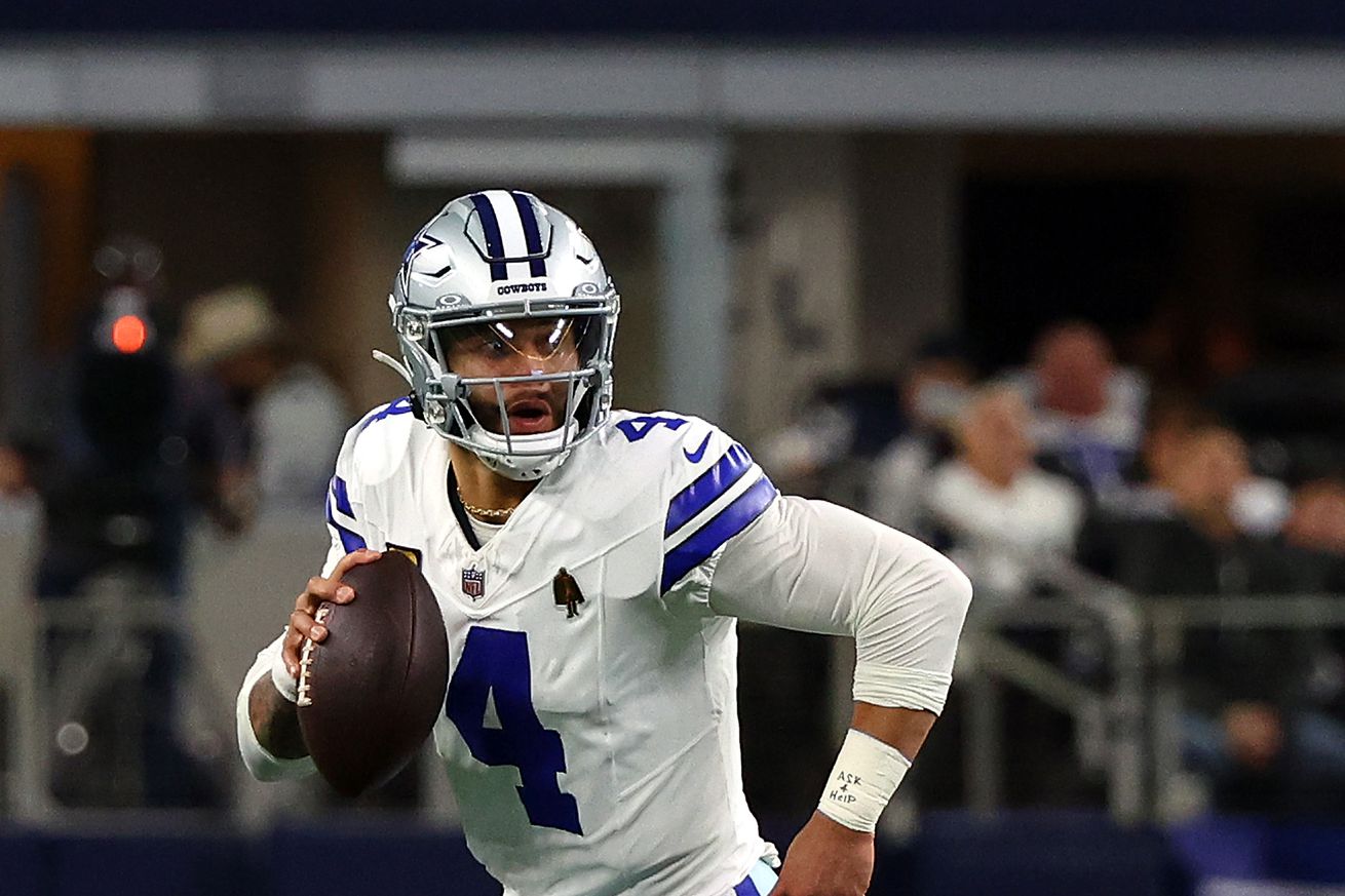 Quarterback Dak Prescott #4 of the Dallas Cowboys scrambles with the ball against the Green Bay Packers at AT&T Stadium on January 14, 2024 in Arlington, Texas.