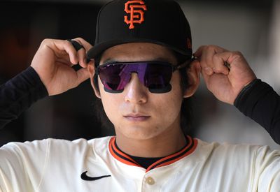 Close up of Jung Hoo Lee putting on glasses. 