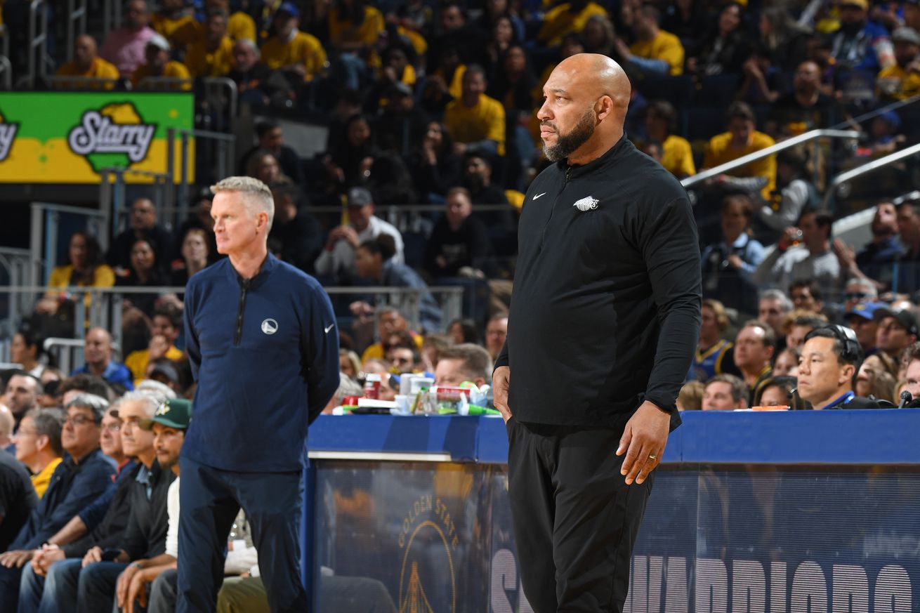 Darvin Ham standing on the sidelines, with Steve Kerr in the background.