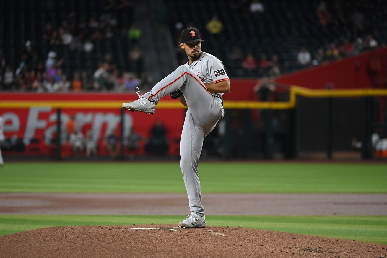 Jordan Hicks kicking his leg up as he begins a pitch.