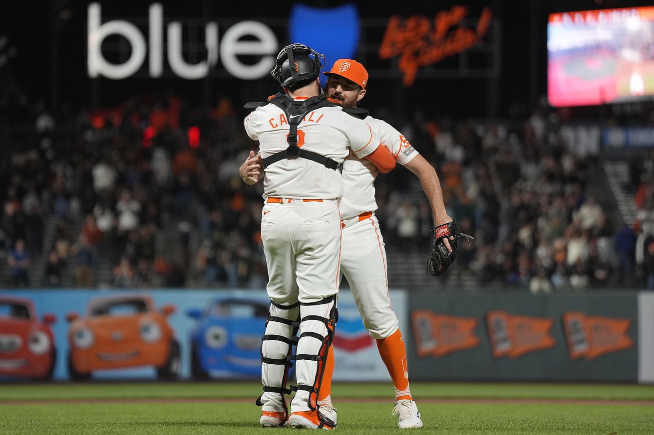 Ryan Walker hugging Curt Casali. 