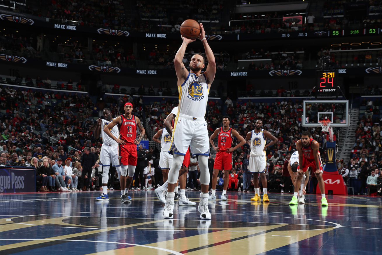 Stephen Curry shoots a free throw during the game against the New Orleans Pelicans during the game in New Orleans, Louisiana. The Pelicans’ court is dark grey and gold for the occasion.