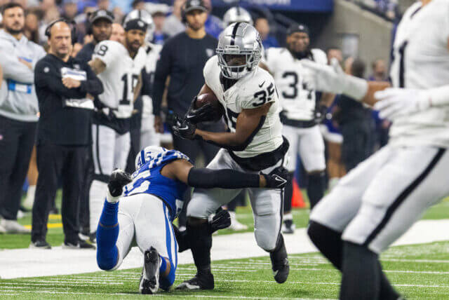 Dec 31, 2023; Indianapolis, Indiana, USA; Las Vegas Raiders running back Zamir White (35) runs the ball while Indianapolis Colts linebacker E.J. Speed (45) defends in the first quarter at Lucas Oil Stadium. Mandatory Credit: Trevor Ruszkowski-USA TODAY Sports Zamir White, Raiders
