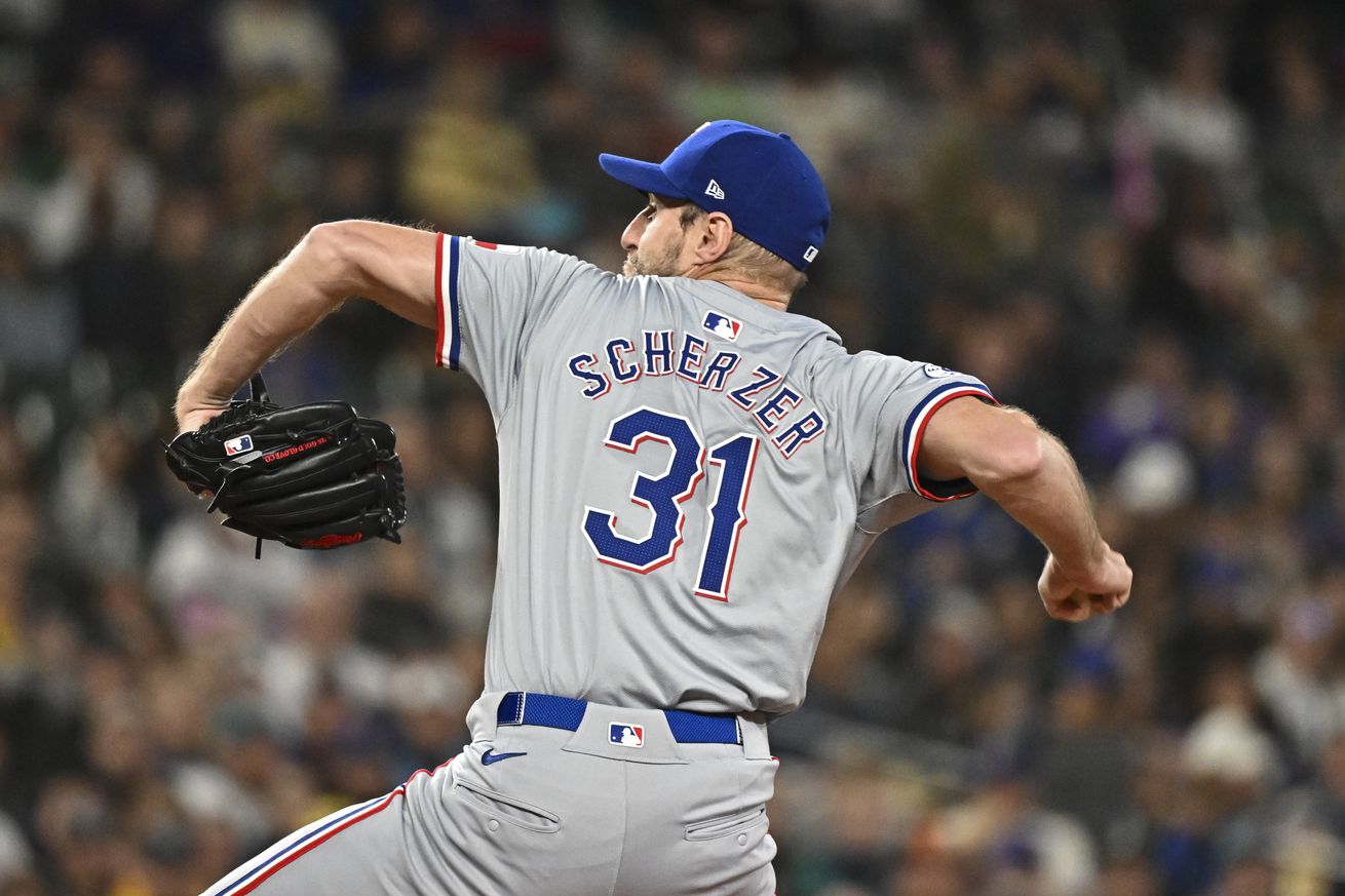 View from behind of Max Scherzer throwing a pitch.