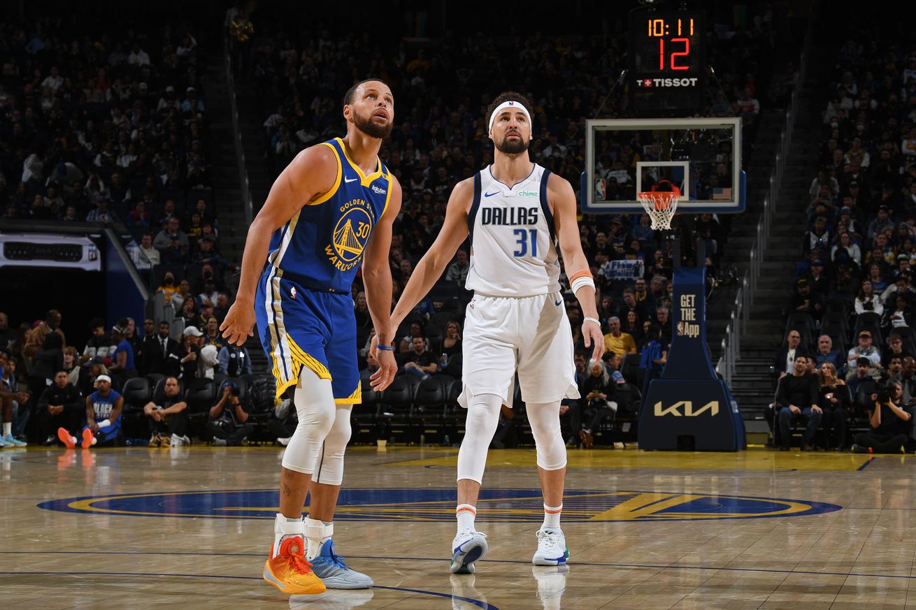 Stephen Curry #30 of the Golden State Warriors and Klay Thompson #31 of the Dallas Mavericks look on during the game on February 23, 2025 at Chase Center in San Francisco, California.