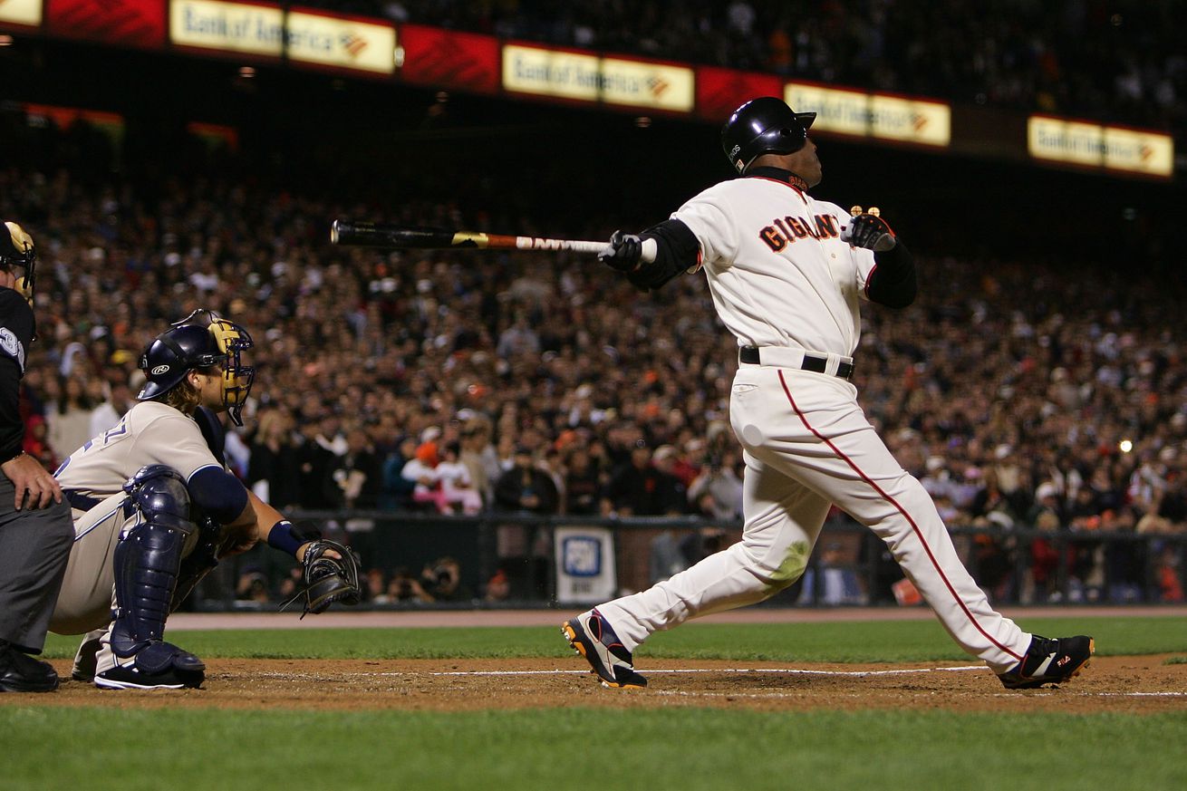 View from the side of Barry Bonds swinging a bat.