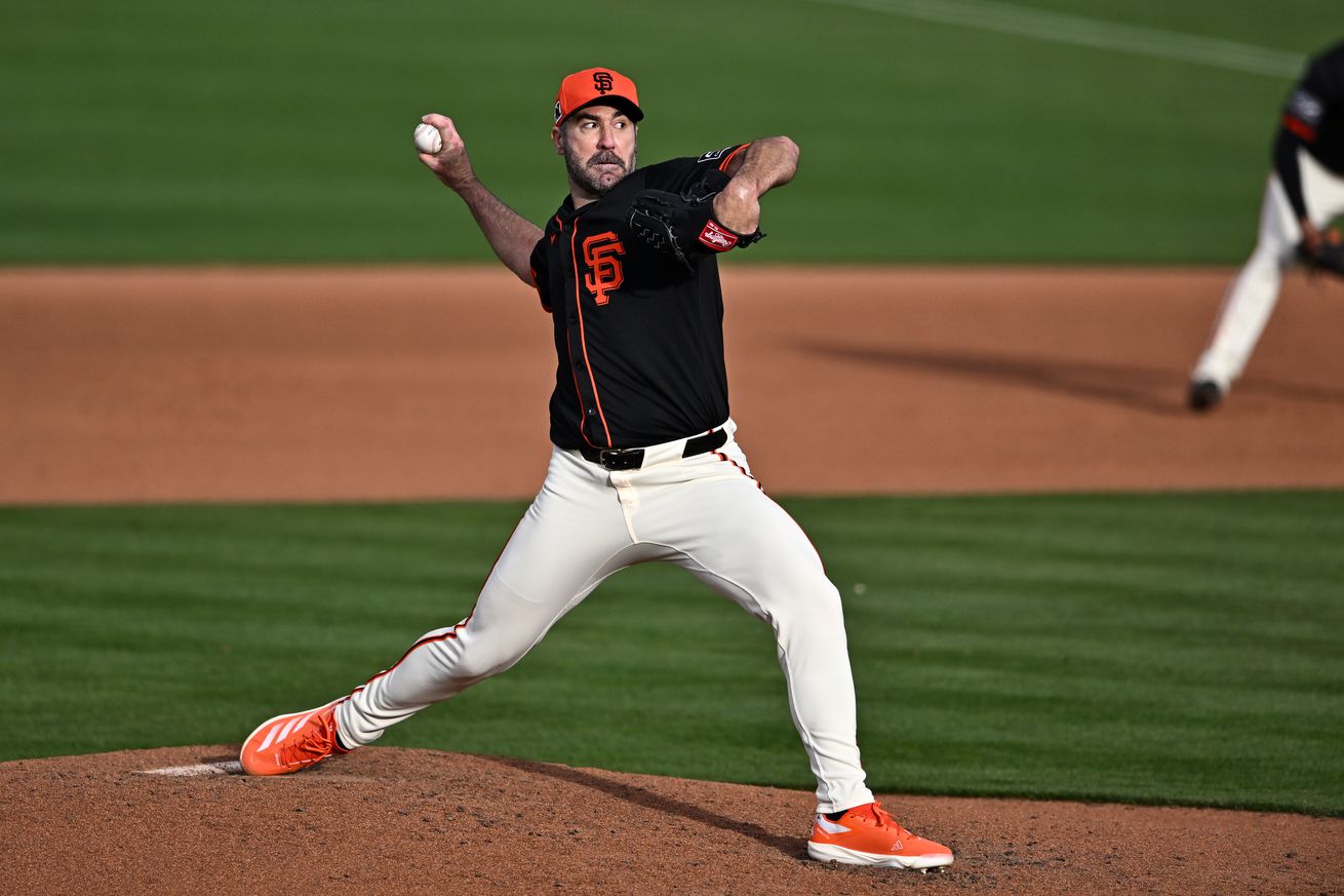 View from the side of Justin Verlander reaching back to throw a pitch.