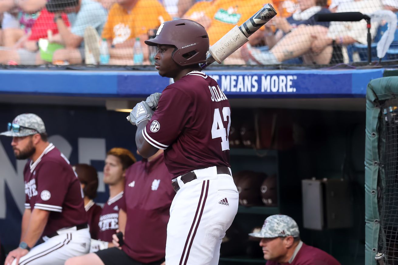 Dakota Jordan holding a bat in the on-deck circle during a college game.