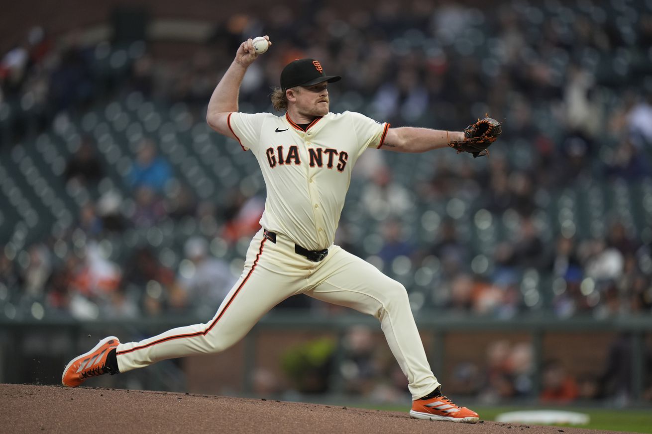 Side view of Logan Webb throwing a pitch.