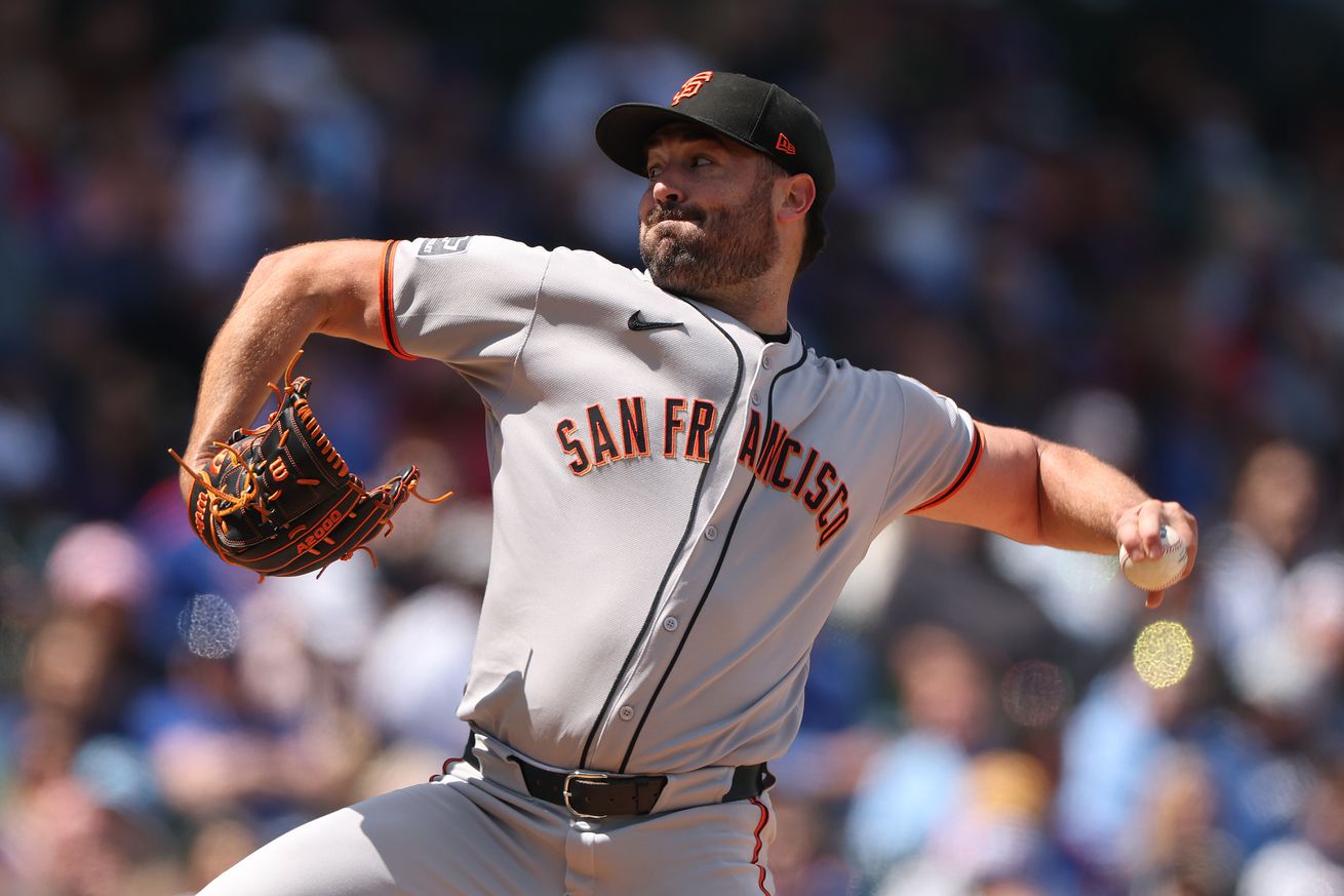 Side view of Robbie Ray reaching back to throw a pitch.