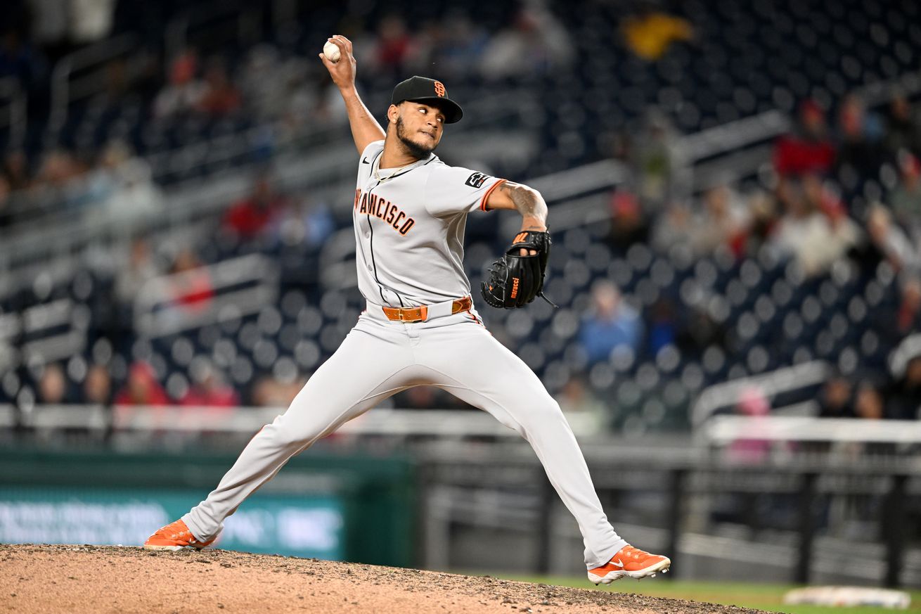 Camilo Doval reaching back to throw a pitch.