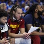 Denver Nuggets forward Aaron Gordon (32) looks over stats