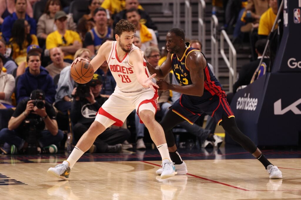 Houston Rockets center Alperen Sengun (28) controls the ball against Golden State Warriors forward Draymond Green