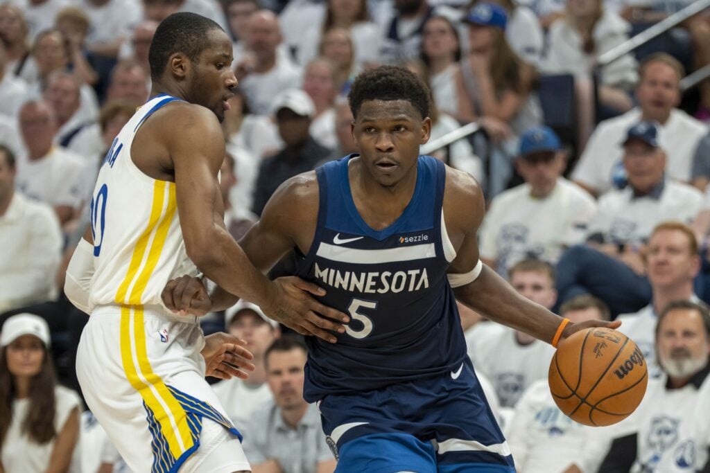 Minnesota Timberwolves guard Anthony Edwards (5) drives to the basket past Golden State Warriors forward Jonathan Kuminga