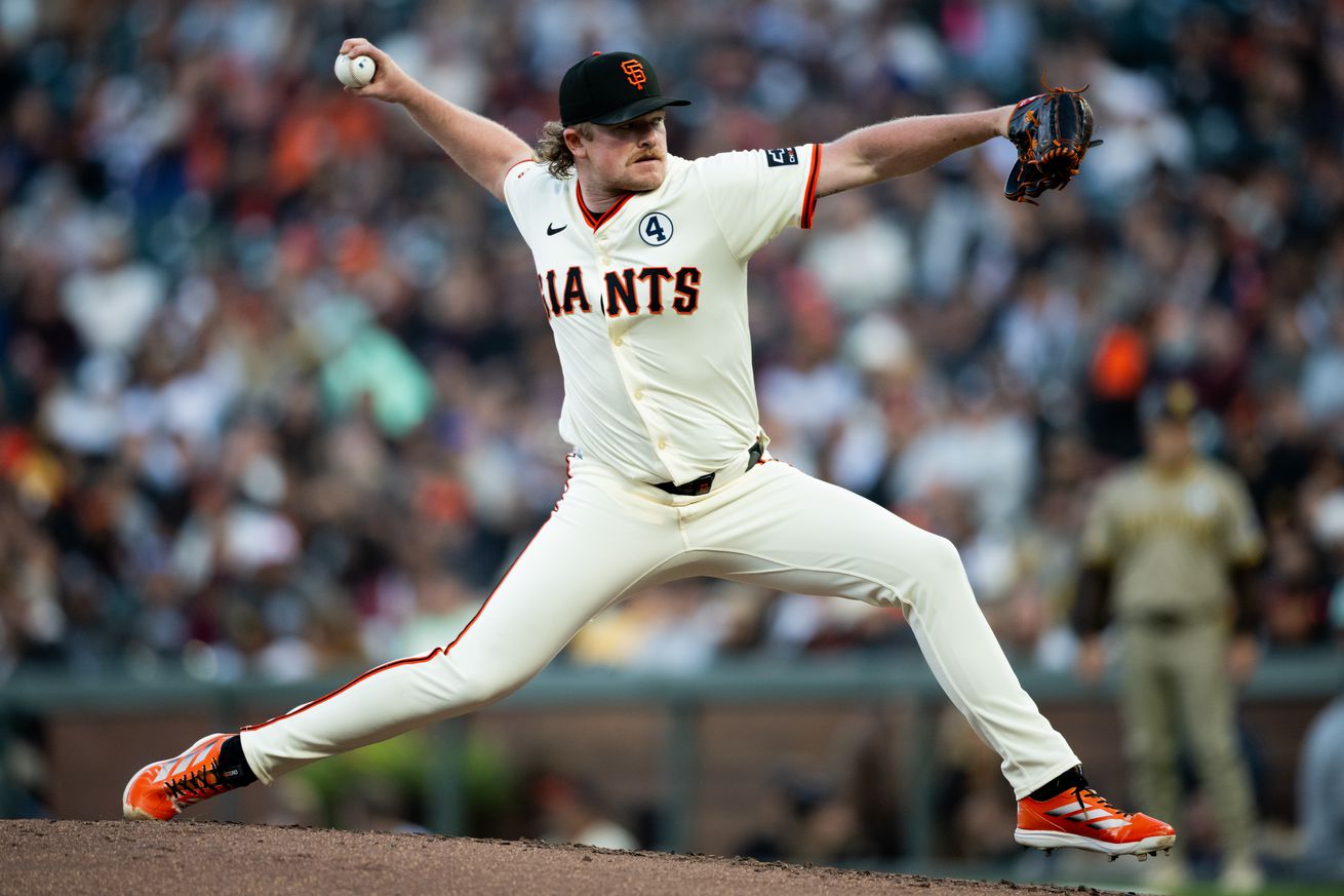Side view of Logan Webb stretched and reaching back to throw a pitch.
