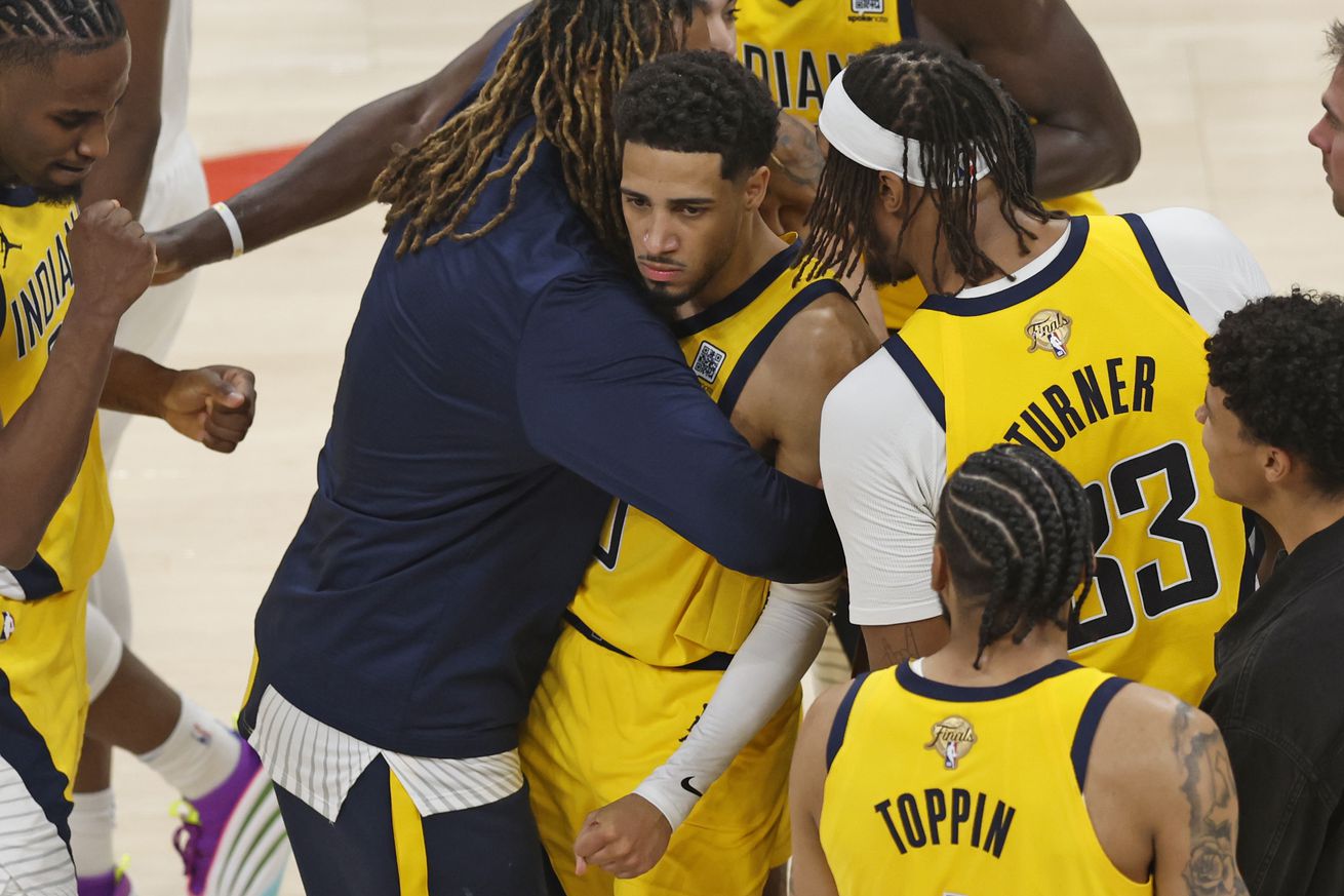 Tyrese Haliburton mobbed by teammates after a game-winner.