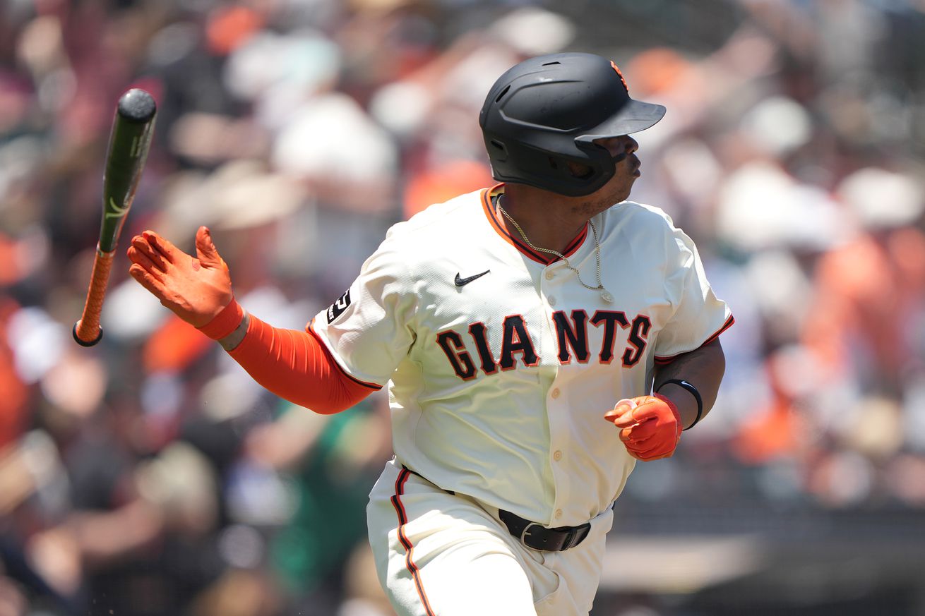 Close up of Rafael Devers flipping his bat after hitting a homer.