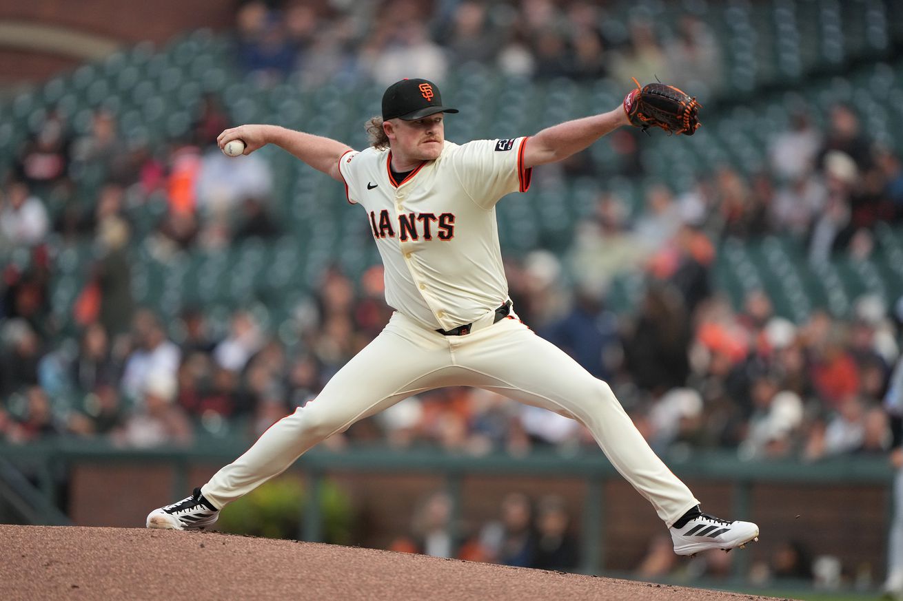 Side view of Logan Webb reaching back to throw a pitch. 