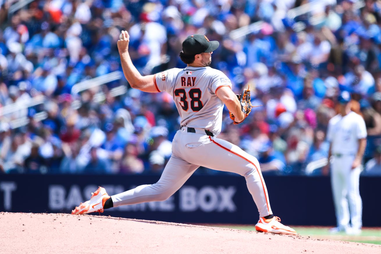 Side view of Robbie Ray throwing a pitch.