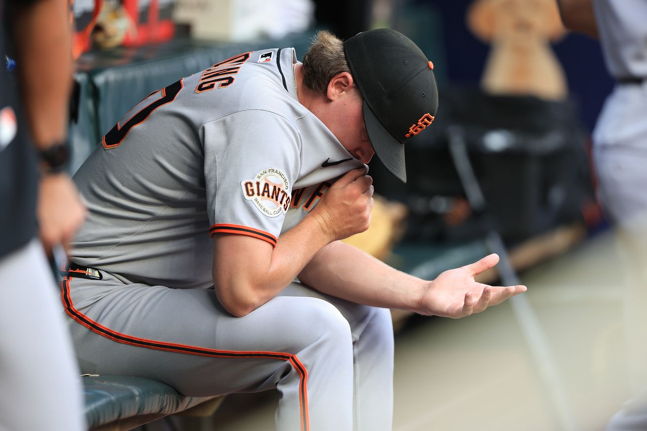 Hayden Birdsong sitting in the dugout disappointed.