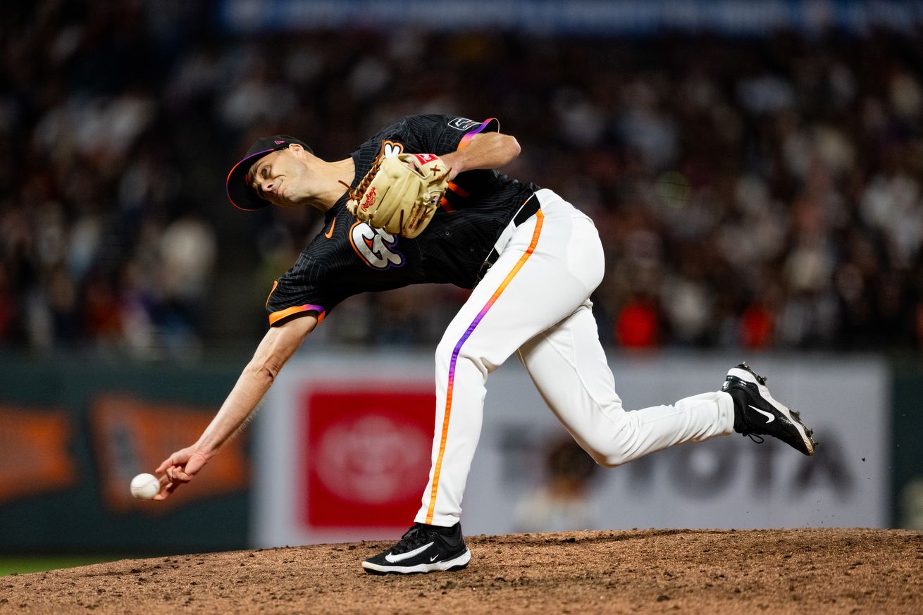 Side view of Tyler Rogers throwing a pitch. 