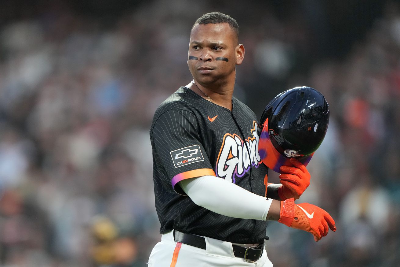 Rafael Devers holding his helmet and looking angry. 