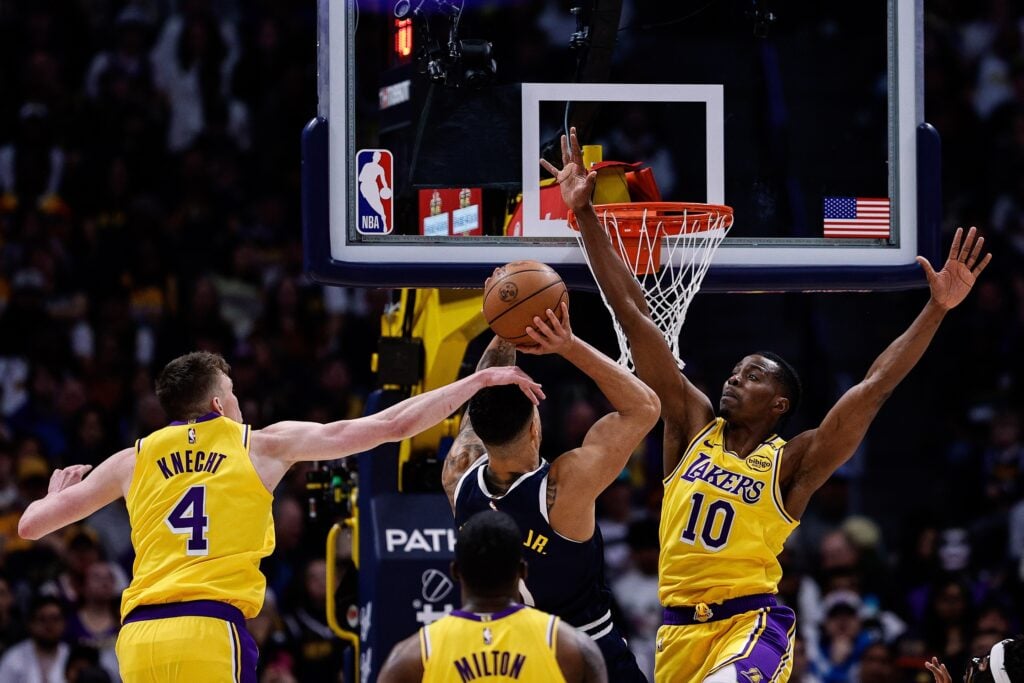 Mar 14, 2025; Denver, Colorado, USA; Denver Nuggets forward Michael Porter Jr. (1) attempts a shot under pressure from Los Angeles Lakers center Christian Koloko (10) and guard Dalton Knecht (4) in the fourth quarter at Ball Arena. Mandatory Credit: Isaiah J. Downing-Imagn Images