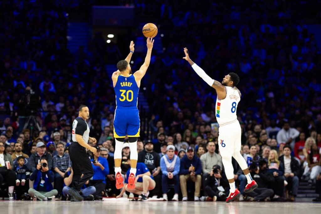 Mar 1, 2025; Philadelphia, Pennsylvania, USA; Golden State Warriors guard Stephen Curry (30) shoots in front of Philadelphia 76ers forward Paul George (8) during the second quarter at Wells Fargo Center. Mandatory Credit: Bill Streicher-Imagn Images