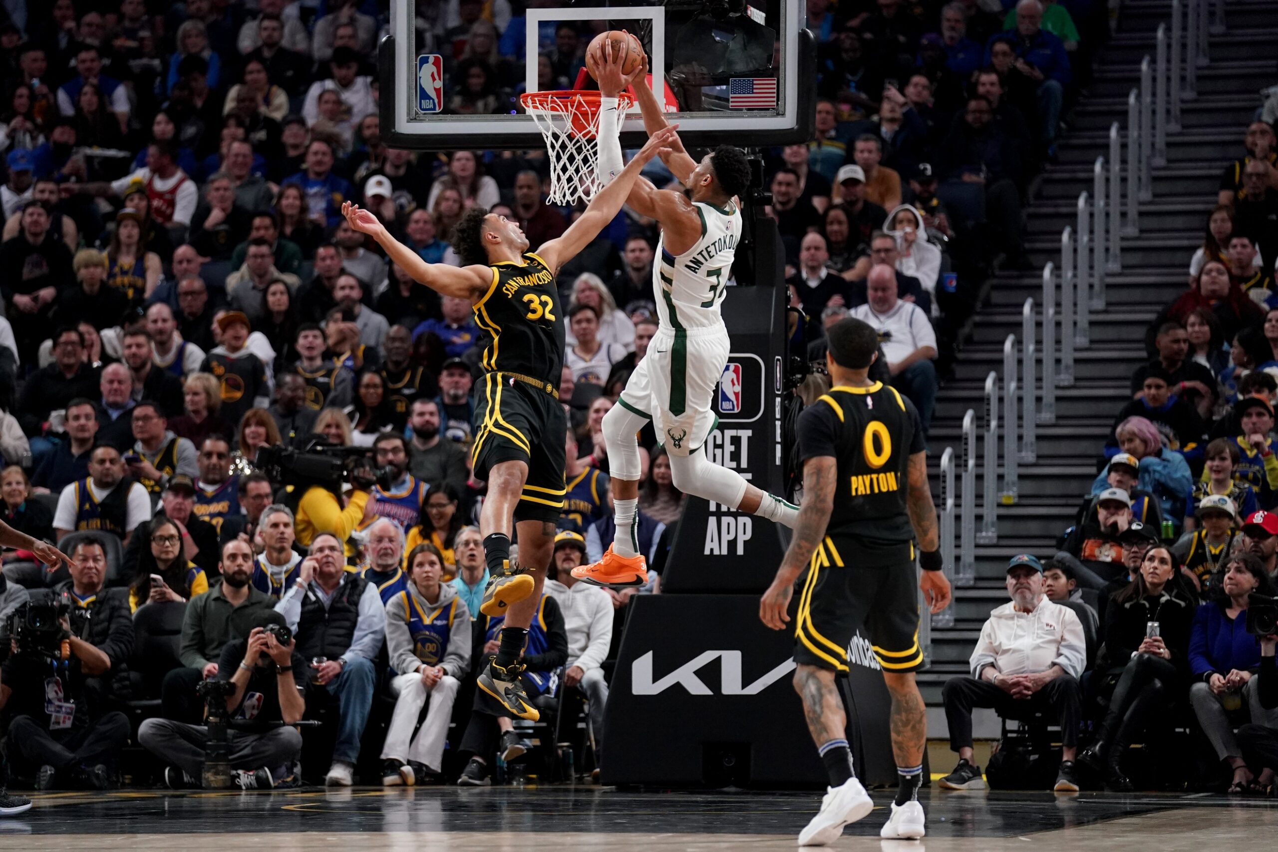 Mar 6, 2024; San Francisco, California, USA; Milwaukee Bucks forward Giannis Antetokounmpo (34) dunks the ball over Golden State Warriors forward Trayce Jackson-Davis (32) in the third quarter at the Chase Center. Mandatory Credit: Cary Edmondson-USA TODAY Sports