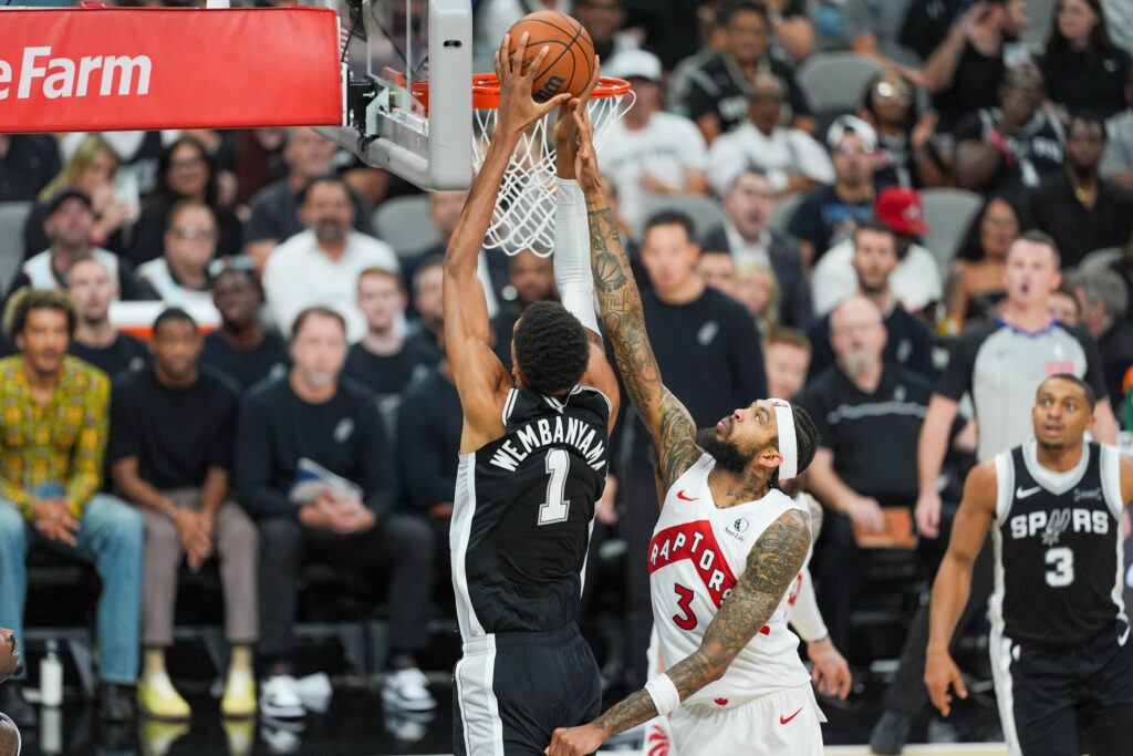 Oct 27, 2025; San Antonio, Texas, USA; San Antonio Spurs forward/center Victor Wembanyama (1) shoots in front of Toronto Raptors forward Brandon Ingram (3) in the second half at Frost Bank Center. Mandatory Credit: Daniel Dunn-Imagn Images