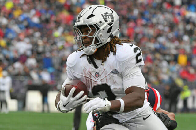 Sep 7, 2025; Foxborough, Massachusetts, USA; Las Vegas Raiders running back Ashton Jeanty (2) rushes the ball against the New England Patriots during the second half at Gillette Stadium. Mandatory Credit: Bob DeChiara-Imagn Images Ashton Jeanty, Raiders